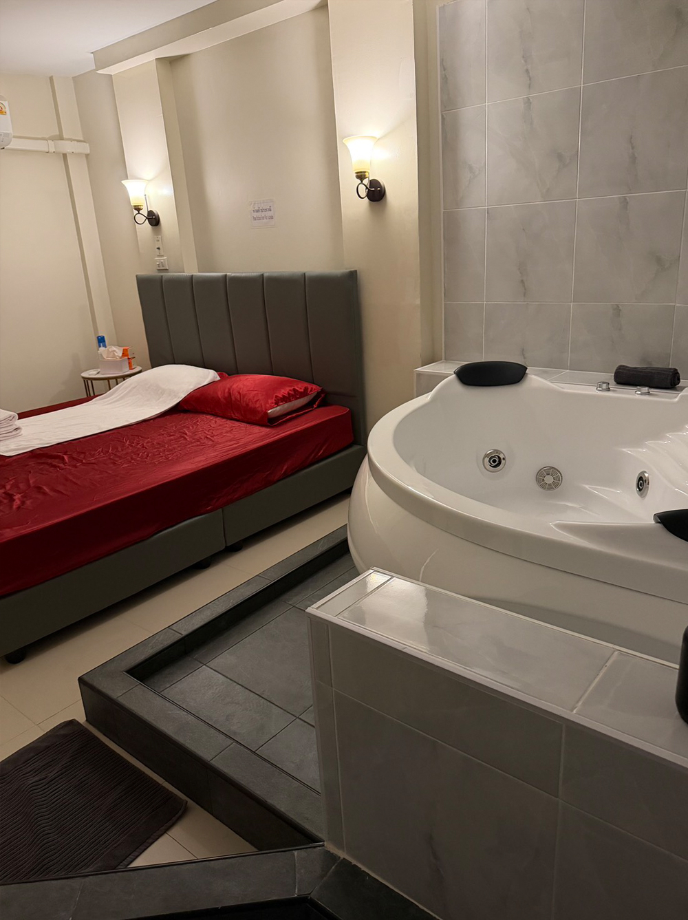 nuru massage room in bangkok with jacuzzi tub and red bed